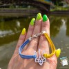Браслет "Герб України. Тризуб". Колір шнура - жовто- блакитний. Основа колір срібло
